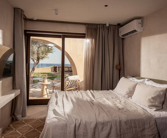 The Echo Of The Sea Beachfront Villa smaller bedroom with double bed and terrace view